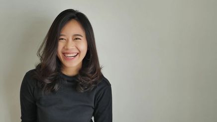 Happy Asian woman with thick hair