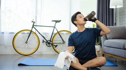 Man drinking water after exercising 