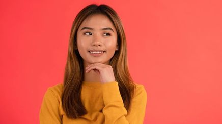Asian teen in a mustard sweater