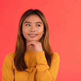Asian teen in a mustard sweater