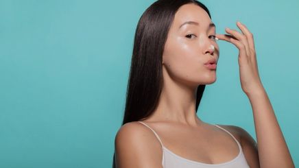 A woman applying a face moisturizer 