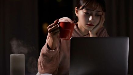 Asian woman in front of laptop
