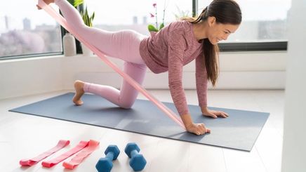 Asian woman stretching with exercise bands