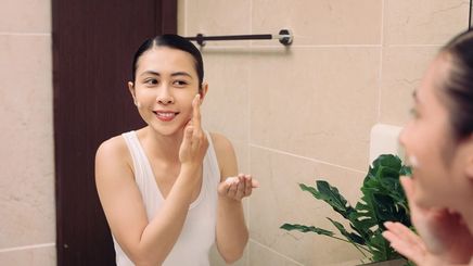 Asian woman washing her face