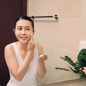 Asian woman washing her face