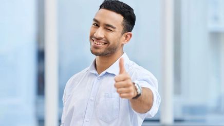 Asian man winking and giving a thumbs up