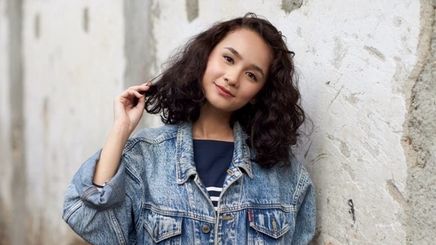 Happy Asian girl with shiny, curly hair