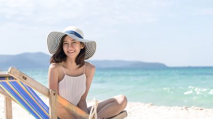 Asian woman sitting on the beach