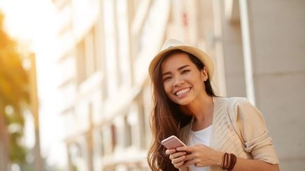 woman smiling while on her phone