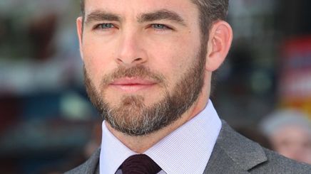 Chris Pine with beard in a gray suit