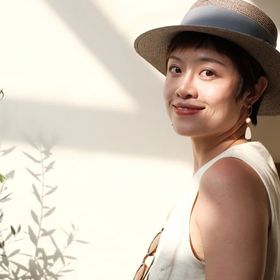 Asian woman wearing a hat outdoors 