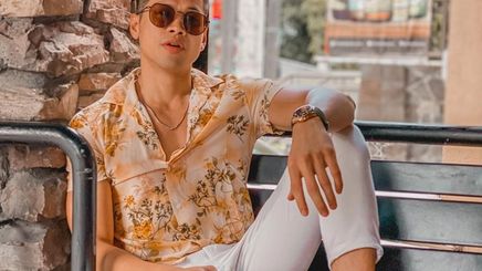 A portrait of Vina Brenica wearing printed shirt and white chinos.