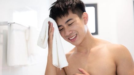 asian young handsome man holding towel