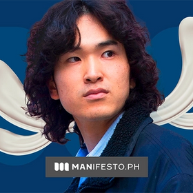 An Asian man with long, curly hair looking to the side.