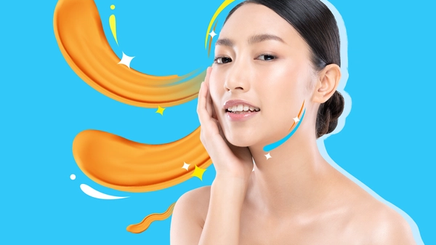 Asian woman with glowing skin touching face