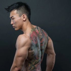Man showing off his back tattoo
