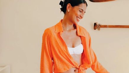 Jasmine Curtis-Smith wearing an orange set and hair clamp style.