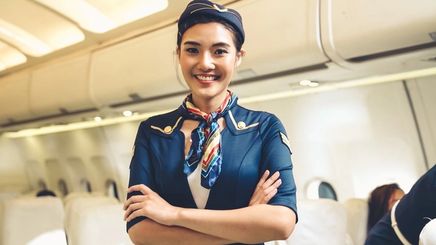Asian flight attendant inside a plane