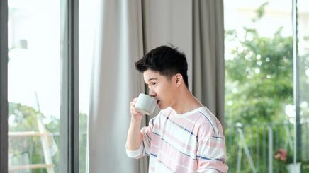 Asian man having morning coffee