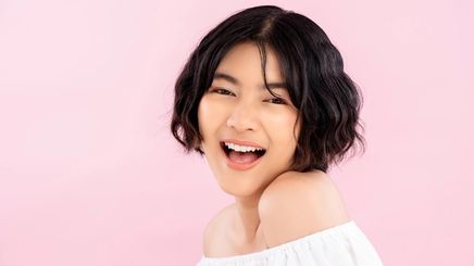 Smiling young Asian woman with Korean short hairstyle 