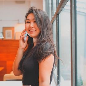Smiling Asian woman with long dark brown hair.