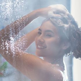 Asian woman showering and washing hair 