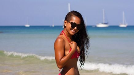 A woman in a bikini with long hair and an undercut