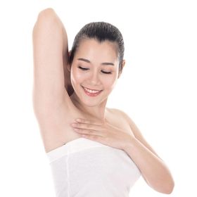 Asian woman looking at her armpits 