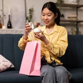 Asian women holding beauty purchase