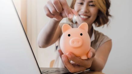 Asian woman with a piggy bank