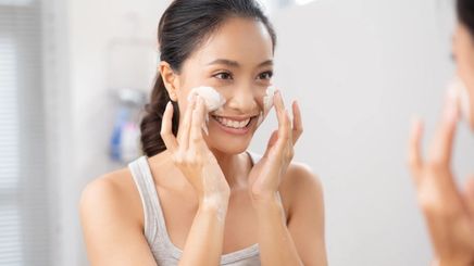 Asian woman washing face