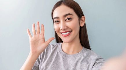 Asian woman in a gray T-shirt. 