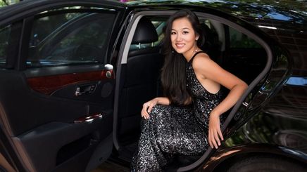 Glamorous Asian woman stepping out of a car