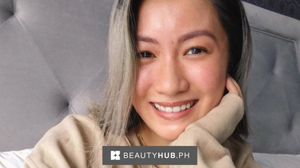 A close-up image of Laureen Uy with her hand on her face