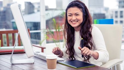 Asian woman smiling while working outdoors