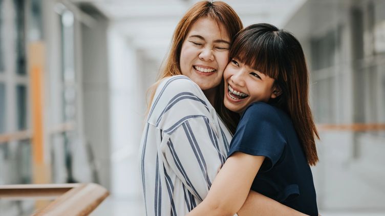 Two female friends hugging each other