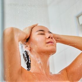 Woman cleaning her hair in the shower.