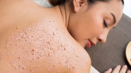 Close-up of body scrub on an Asian woman’s back.