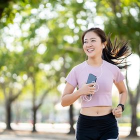 Healthy Asian woman running outdoors