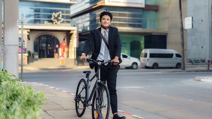 Asian businessman on a bike