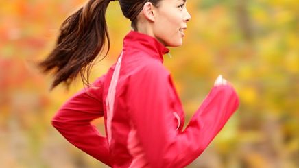 Woman wearing a ponytail running outdoors