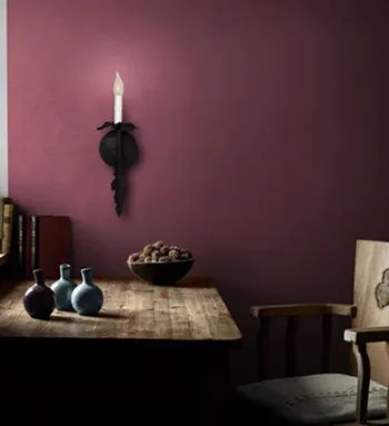 A moody dining room with decorative iron wall lighting
