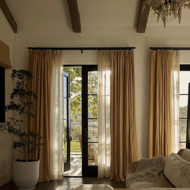 Curtains framing a bright doorway