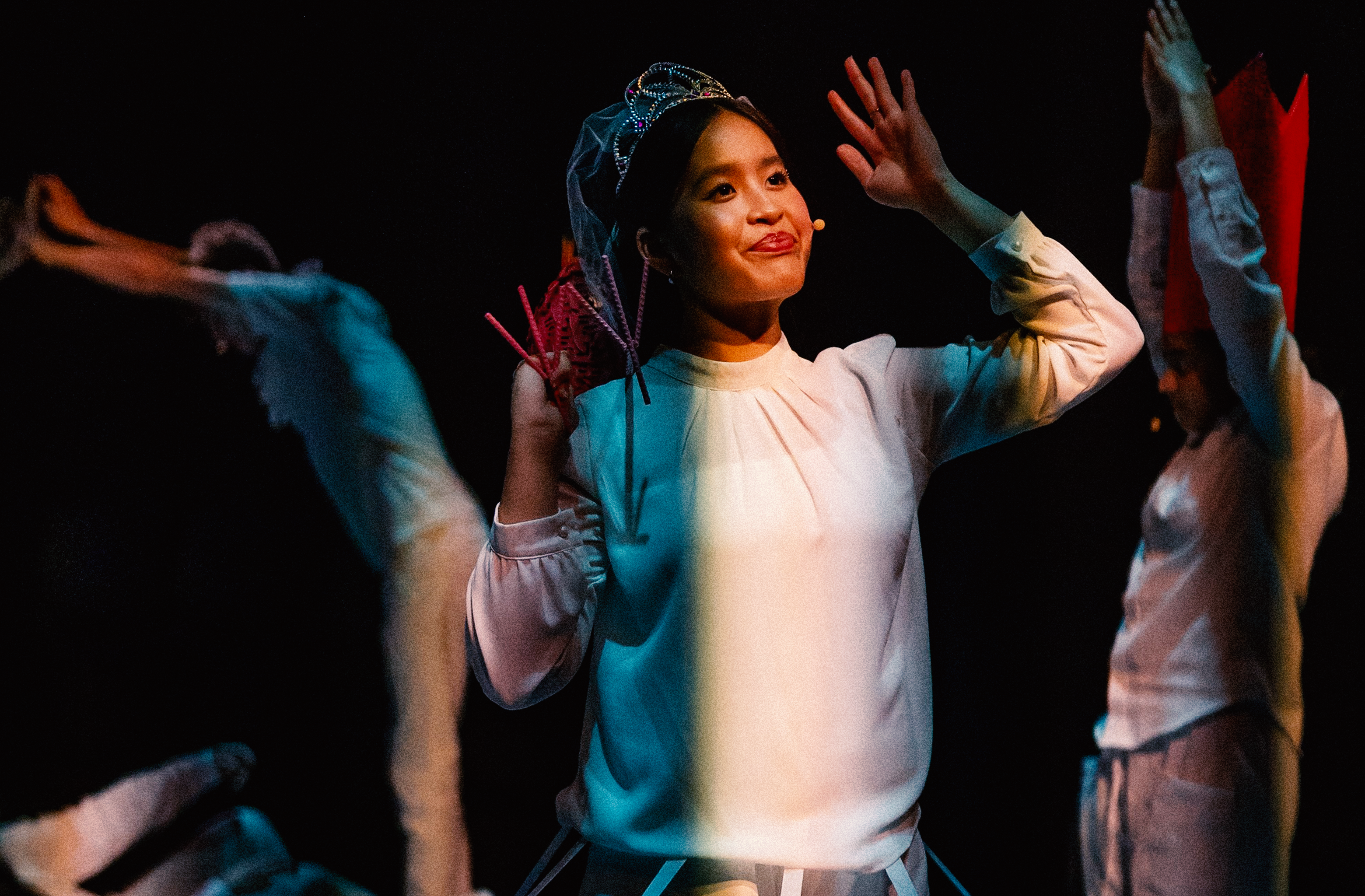 A dancer mid-performance in stage light