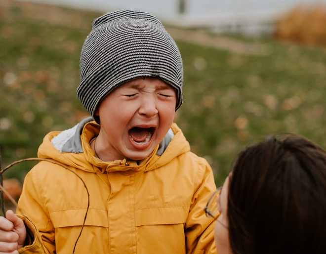 Gutt hylgråter i sinne og mor forsøker å få kontakt med barnet.