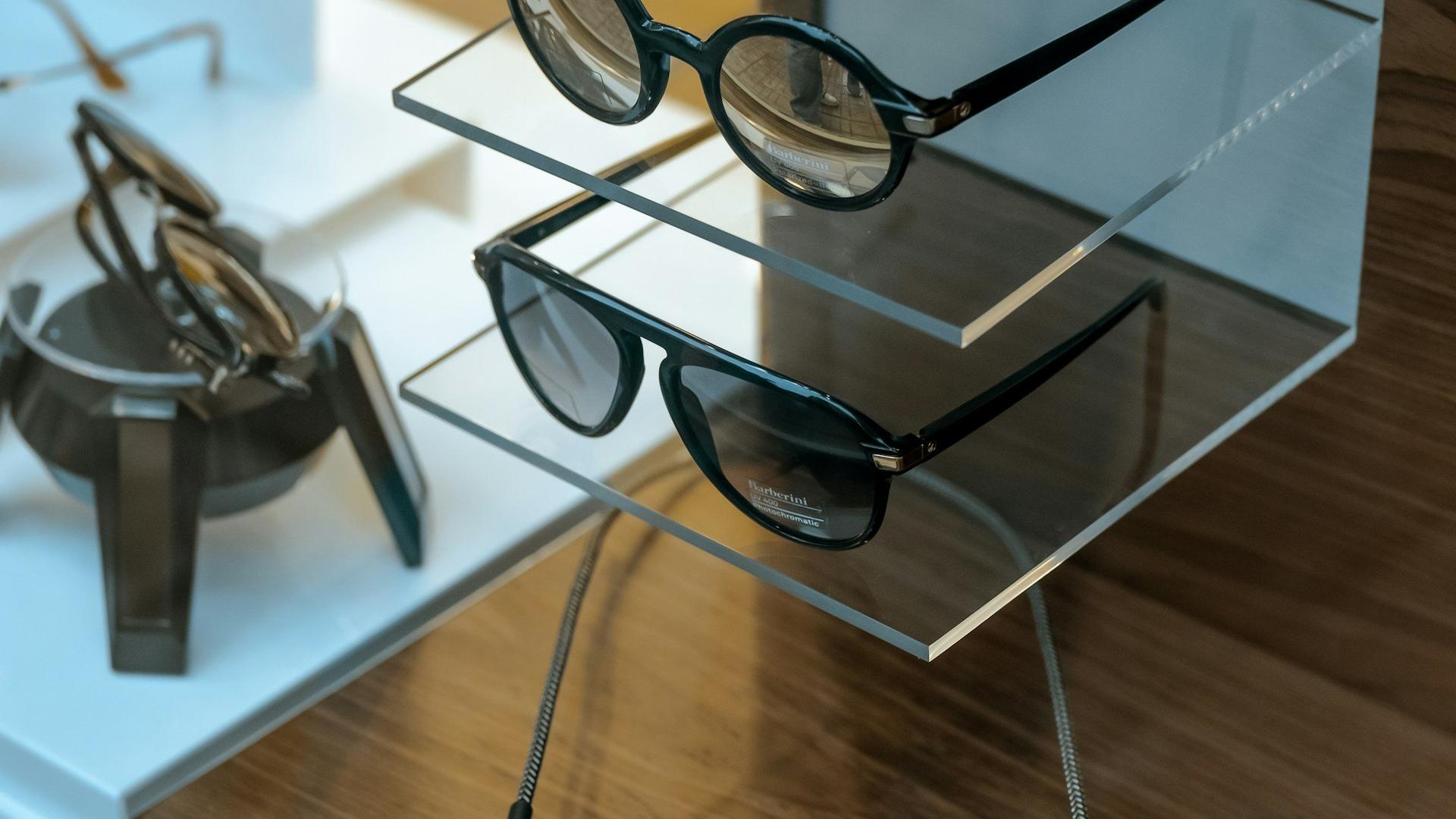 Lunettes de soleil exposees sur une etagere en verre dans une boutique