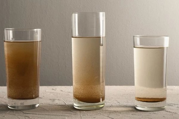 Picture of three glasses each with different levels of particulate in them