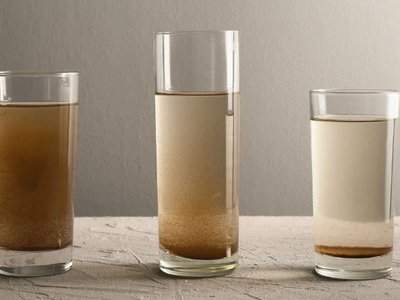 Picture of three glasses each with different levels of particulate in them