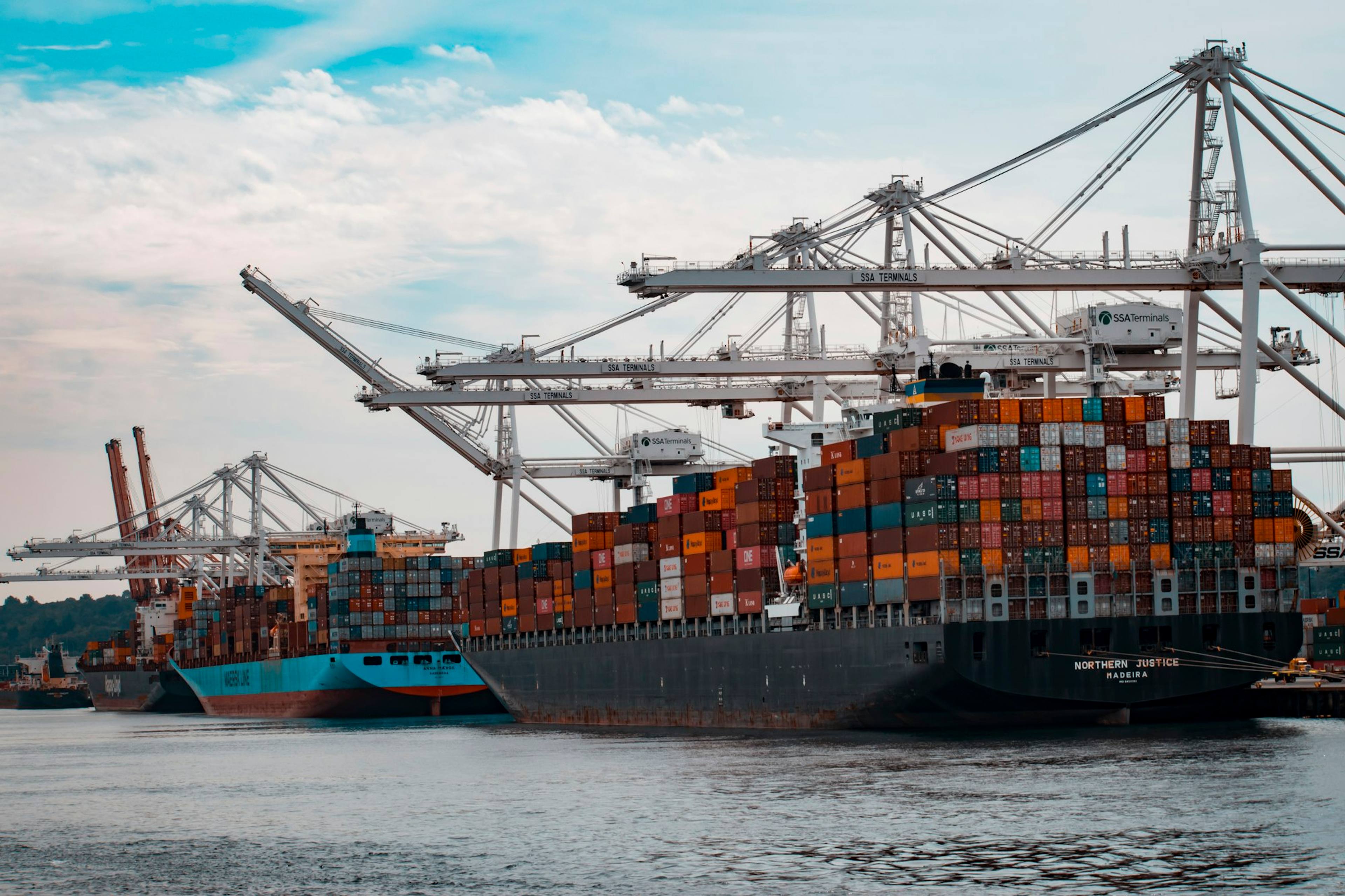 A container ship being loaded by cranes at a port