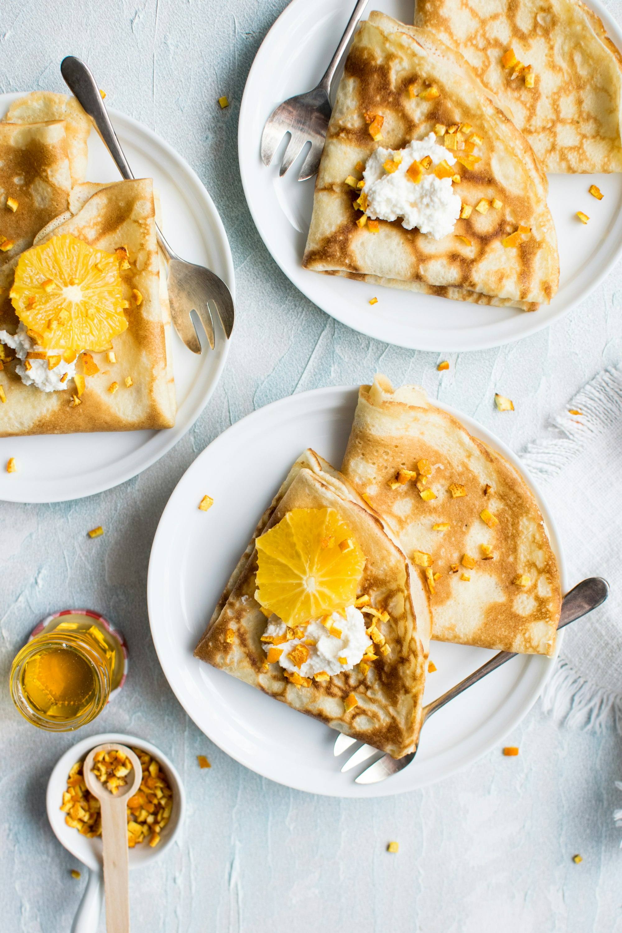 Folded crepes served on white plates